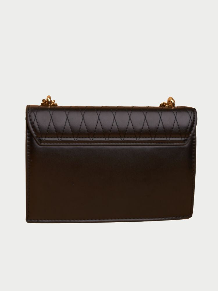 Small leather sling bag with gold chain straps and a beaded design at the front.