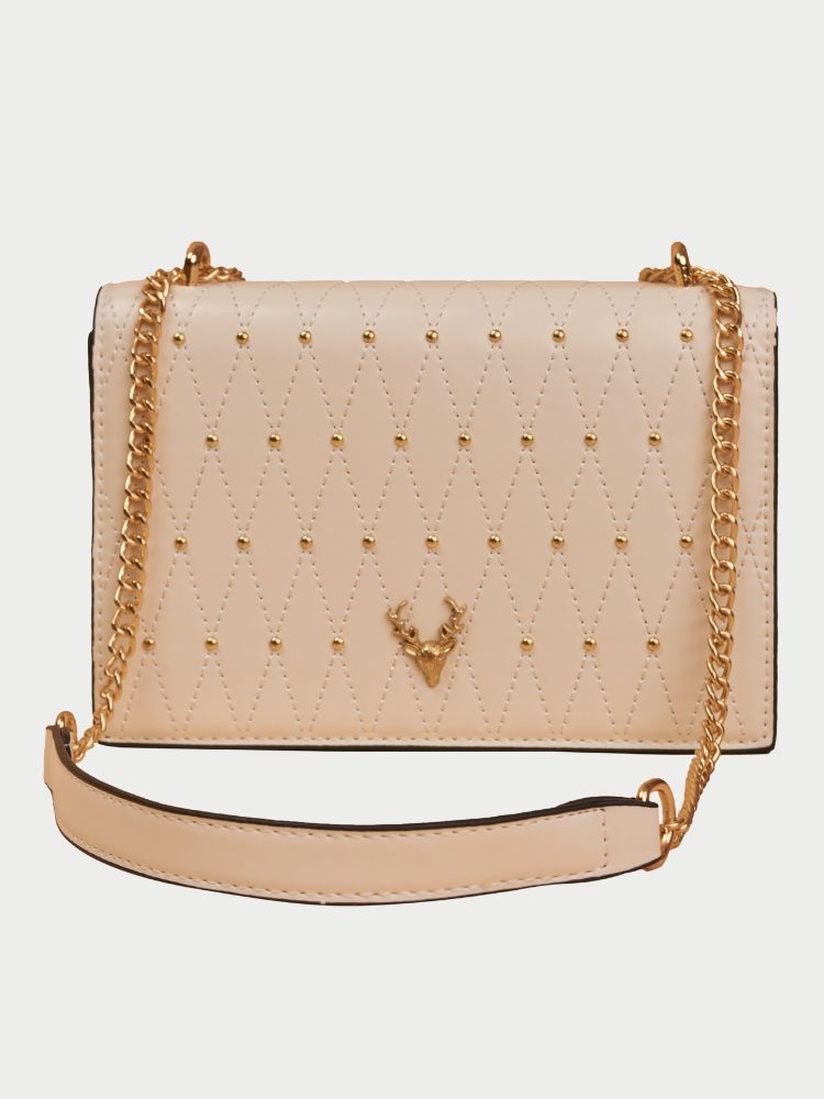 Small leather sling bag with gold chain straps and a beaded design at the front.