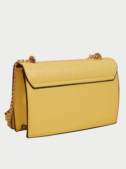 Small leather sling bag with gold chain straps and a beaded design at the front.