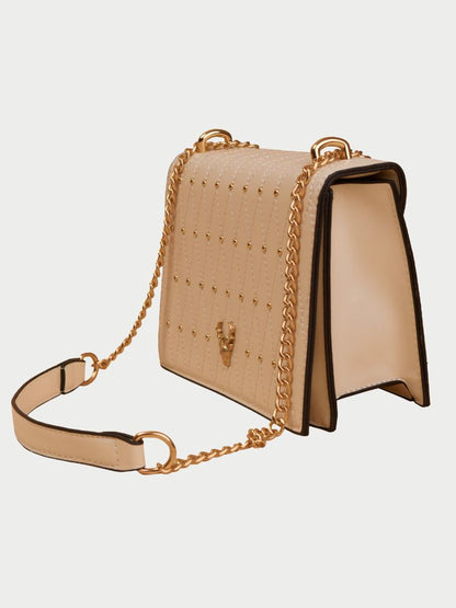 Small leather sling bag with gold chain straps and a beaded design at the front.