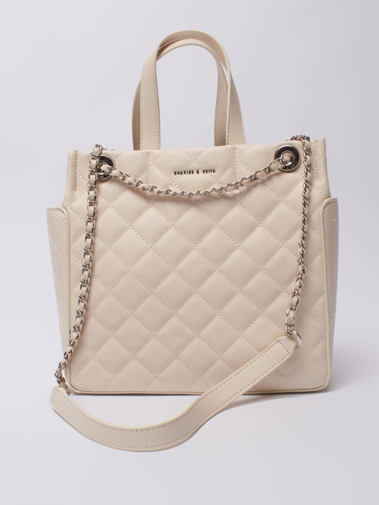 sophisticated leather tote bag with luxurious gold detailing on the handles