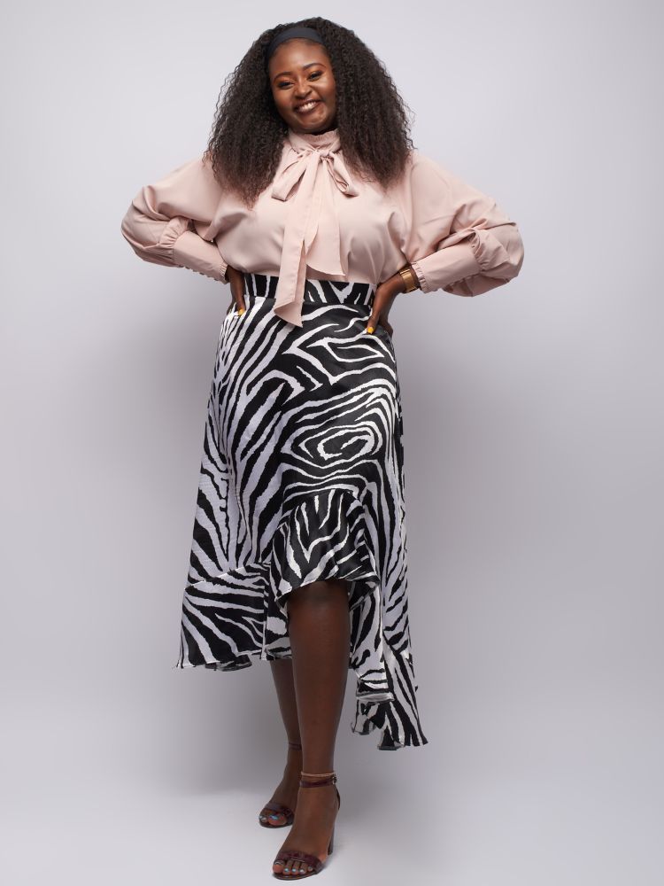 mock neck top boasts intricate frill detailing on the neckline and cuffs for a feminine touch.