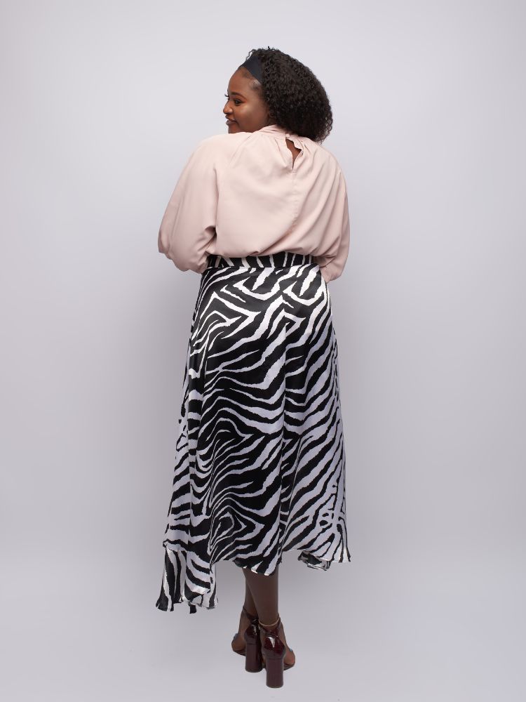 mock neck top boasts intricate frill detailing on the neckline and cuffs for a feminine touch.
