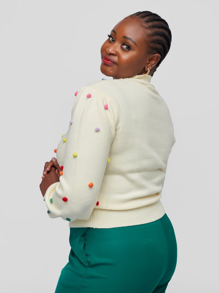 Sweater with a chic mock neckline, long sleeves, and a flattering waist-length fit with colourful knitted balls.