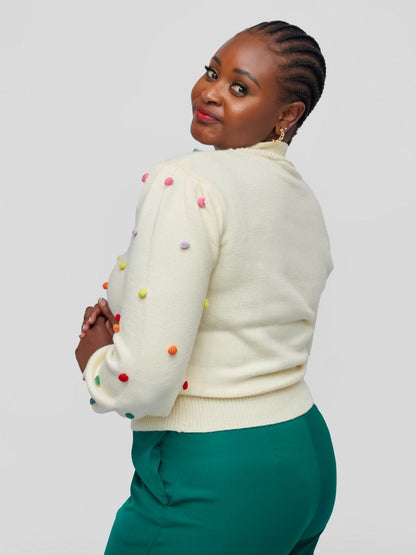 Sweater with a chic mock neckline, long sleeves, and a flattering waist-length fit with colourful knitted balls.